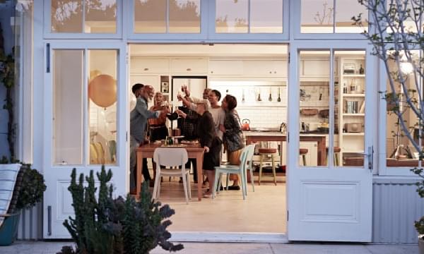 Large family makes a toast in kitchen on a summer evening